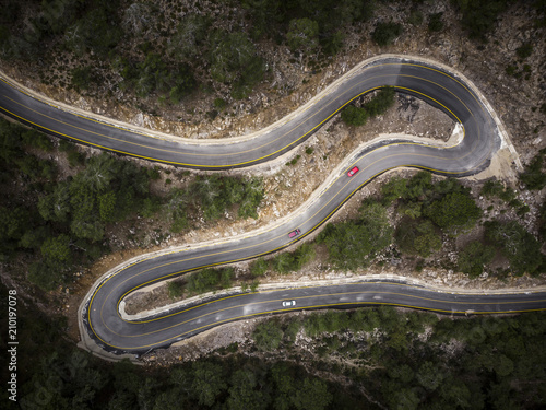 Tablou pe pânză Aerial view of a winding mountain road surrounded in forest, Fethiye, Turkey
