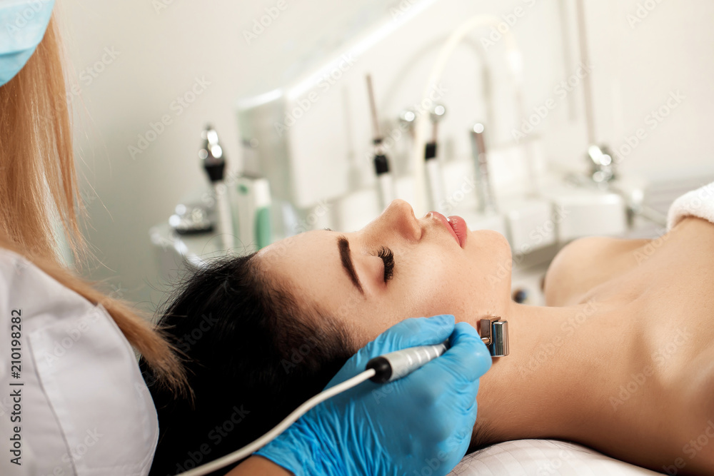 Beautician makes cleaning of face in spa salon. Beautician makes cleaning of face in spa salon.