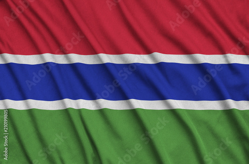 Gambia flag  is depicted on a sports cloth fabric with many folds. Sport team banner photo