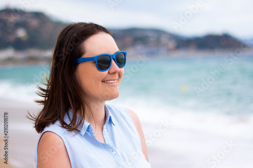 portrait of young woman over summer beach background