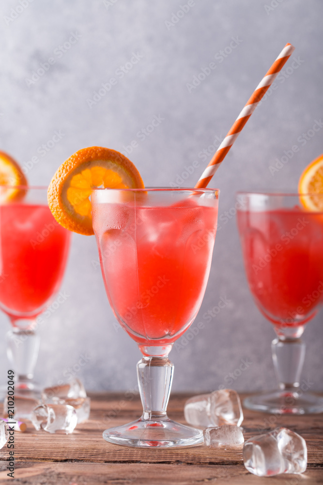 three glasses of lemonade with orange