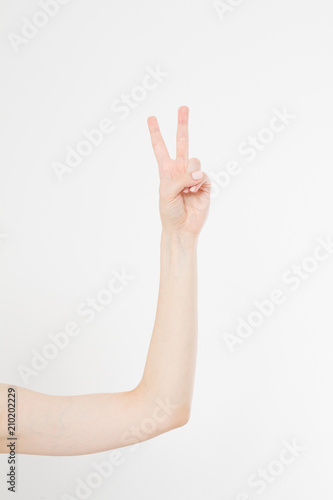 Hand showing the sign of victory or peace closeup isolated on white background.Front view. Mock up. Copy space. Template. Blank.