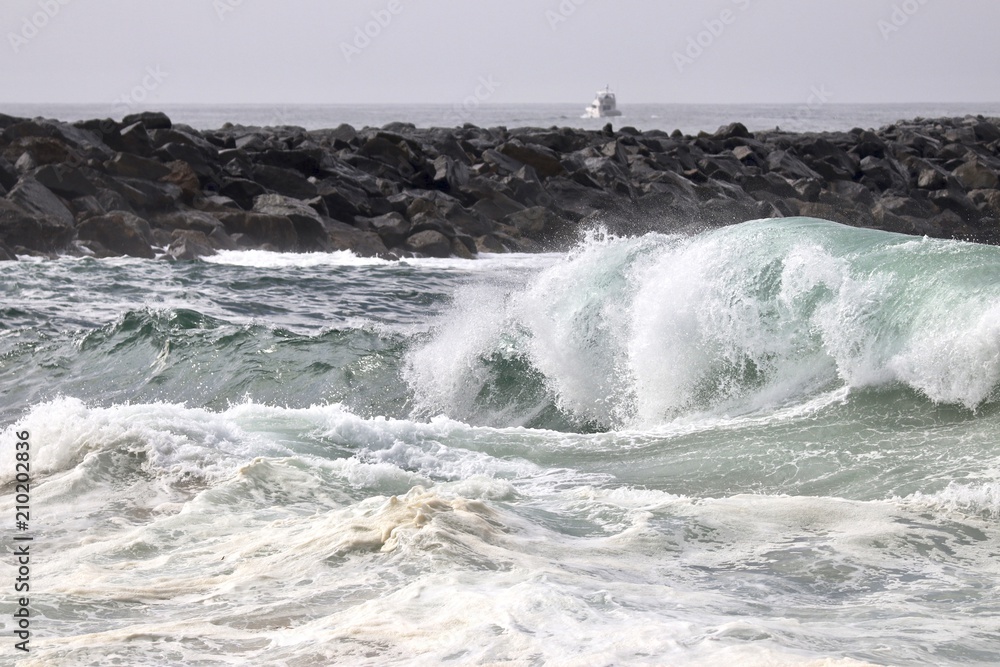 Large powerful wave crashing on the shore Large powerful wave crashing on the shore