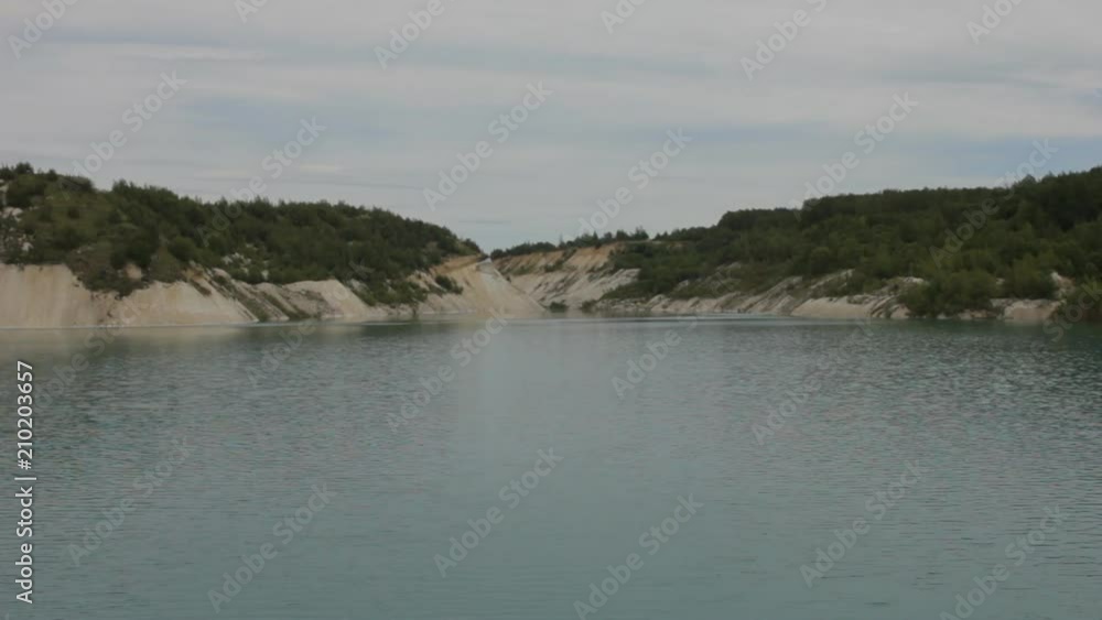 A blue lake, around which a forest, a quarry, a static frame A blue lake, around which a forest, a quarry, a static frame