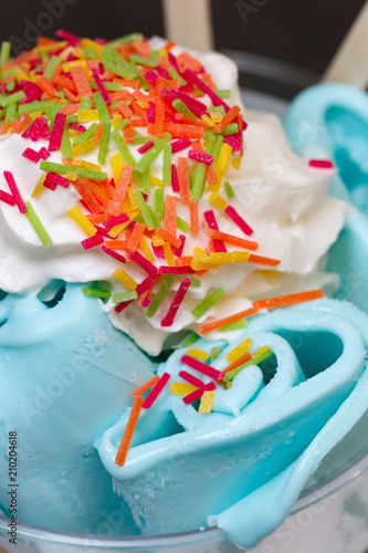 Roll ice cream is made by hand on the freezer. Sweet dessert made with natural colored caramel and blue dye.