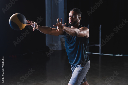 muscular african american sportsman training with ball in gym © LIGHTFIELD STUDIOS