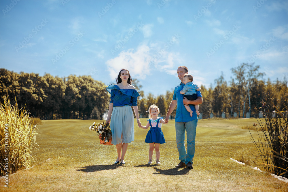 Happy young family spending time together outside in green nature. Happy young family spending time together outside in green nature.
