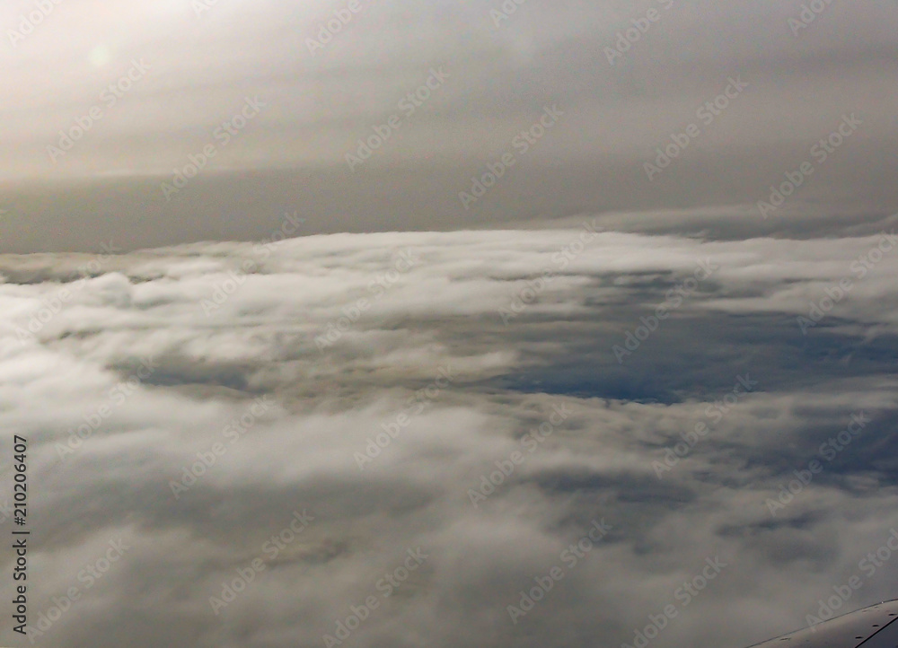 Sky and Clouds View from above through a window airplane at sunrise