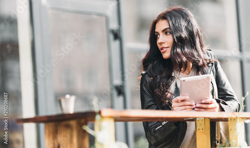 Young pretty spanish woman in cafe in city centre