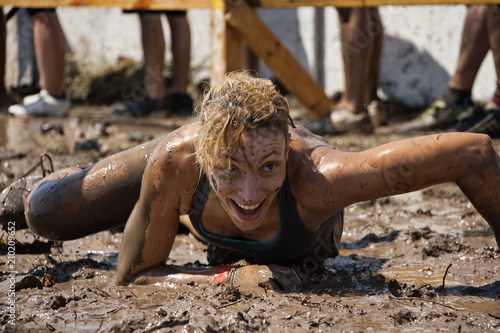 A woman crawling in the mud
