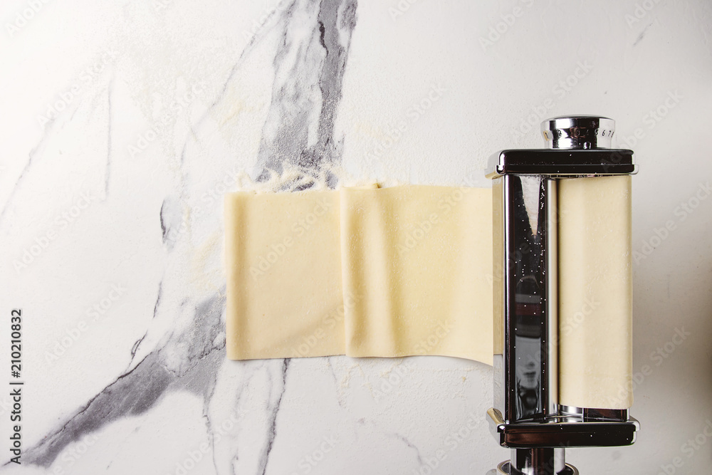 Rolled dough for homemade italian uncooked pasta lasagna from pasta machine maker with semolina