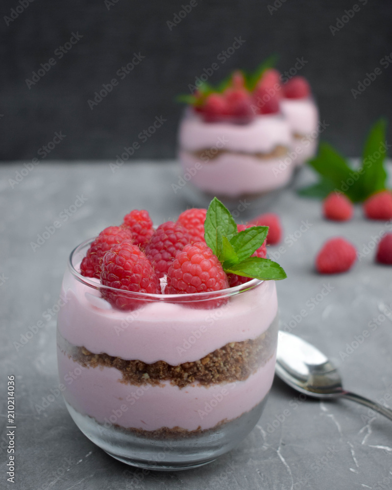 Sweet raspberry mousse in glass bowl on dark background Sweet raspberry mousse in glass bowl on dark background