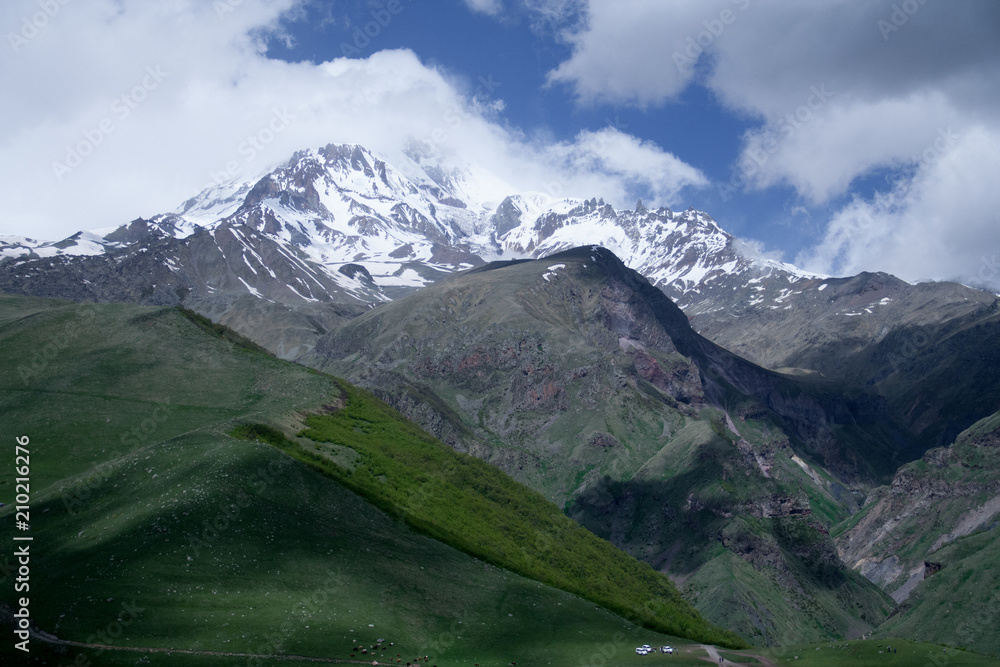 Fototapeta premium View of mountain Kazbegi with snow on top in sunny day