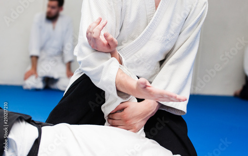 Принти на полотні Aikidoka uses the technique joint lockon the opponent during the training of aik