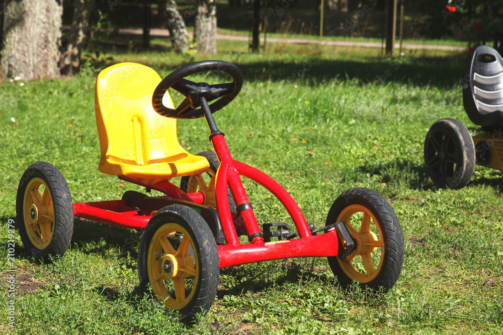 children pedal car awaiting riders at children park children pedal car awaiting riders at children park