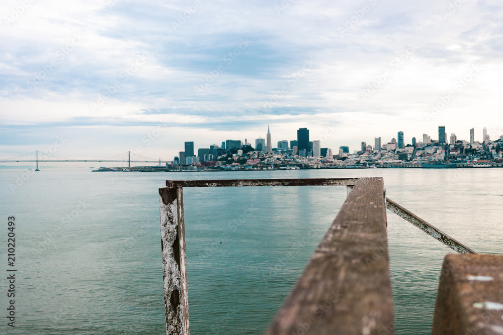 San Francisco Skyline from Alcatraz with weathered wooden handrail