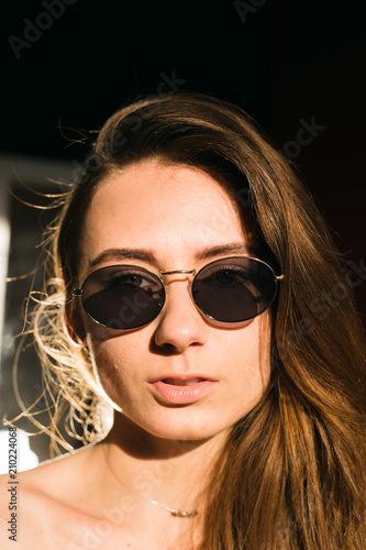 Portraits of beautiful brunette girl in sunglasses