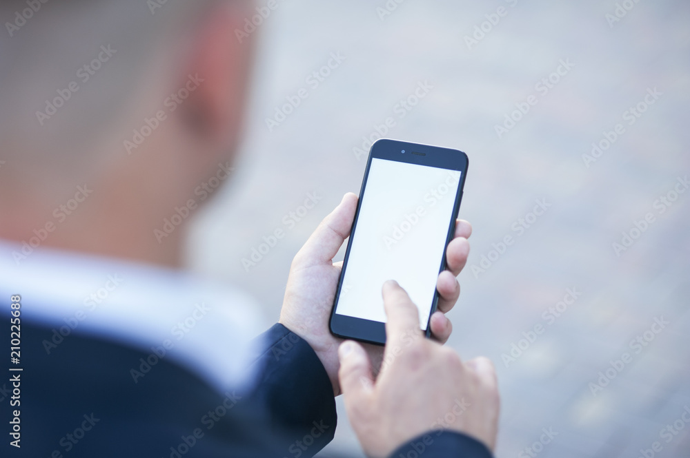Touch screen of a mobile phone, in the hand of a businessman. Photo for Mock Up