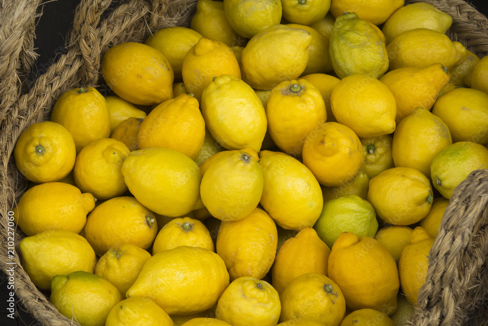 Fresh juicy lemons inside a wicker basket