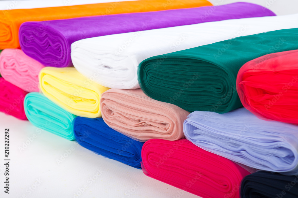 Four Rolls Of Fabric Neon Colors. Tulle. Neatly Folded In A Row. On A Dark  Background Stock Photo, Picture and Royalty Free Image. Image 123633783.