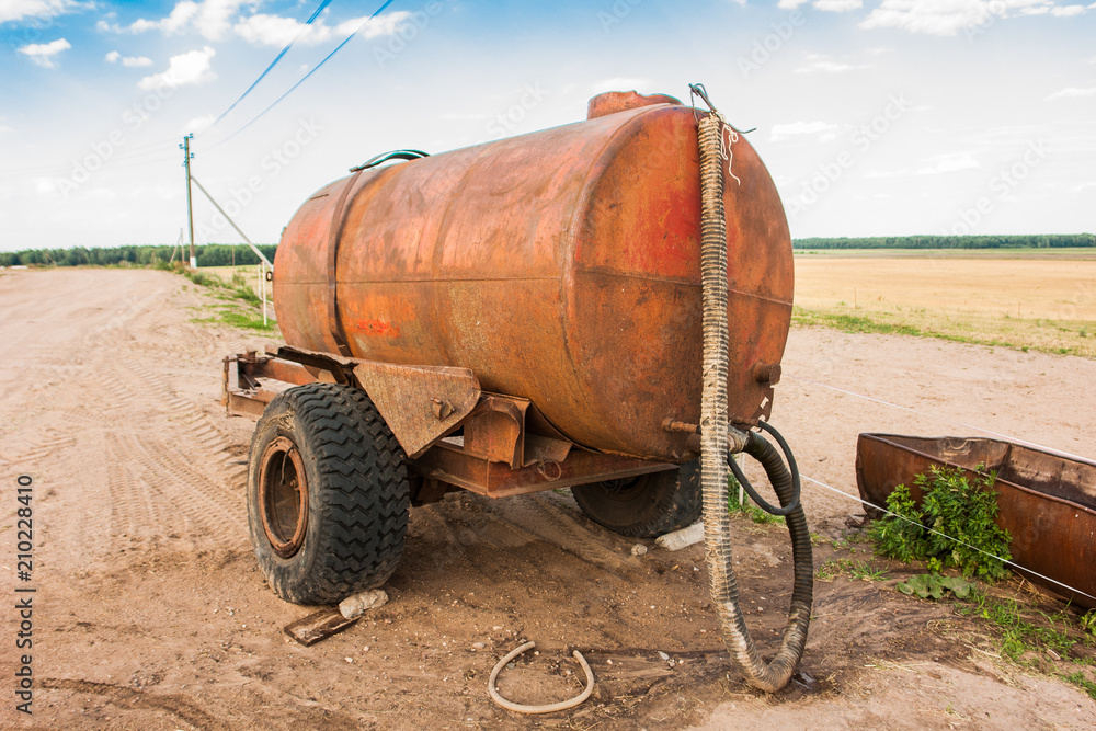 trailer with water for cattle on the field trailer with water for cattle on the field