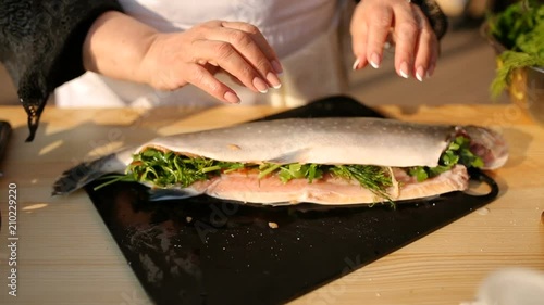 Fresh raw trout with spices on a wooden board. The concept of healthy food and diet. Close-up.