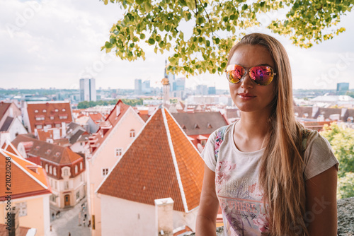 Young girl exploring Tallinn city including old town, modern district Rotermann photo