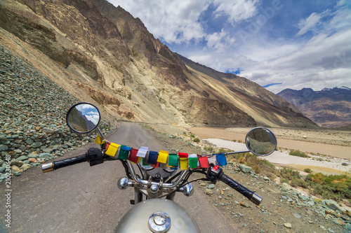 Motorcycling the Leh Manali Highway, a high altitude road that traverses the great Himalayan range, Ladakh, India. View from the rider side photo