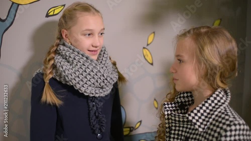 Two School Girls Talking secret to each other photo