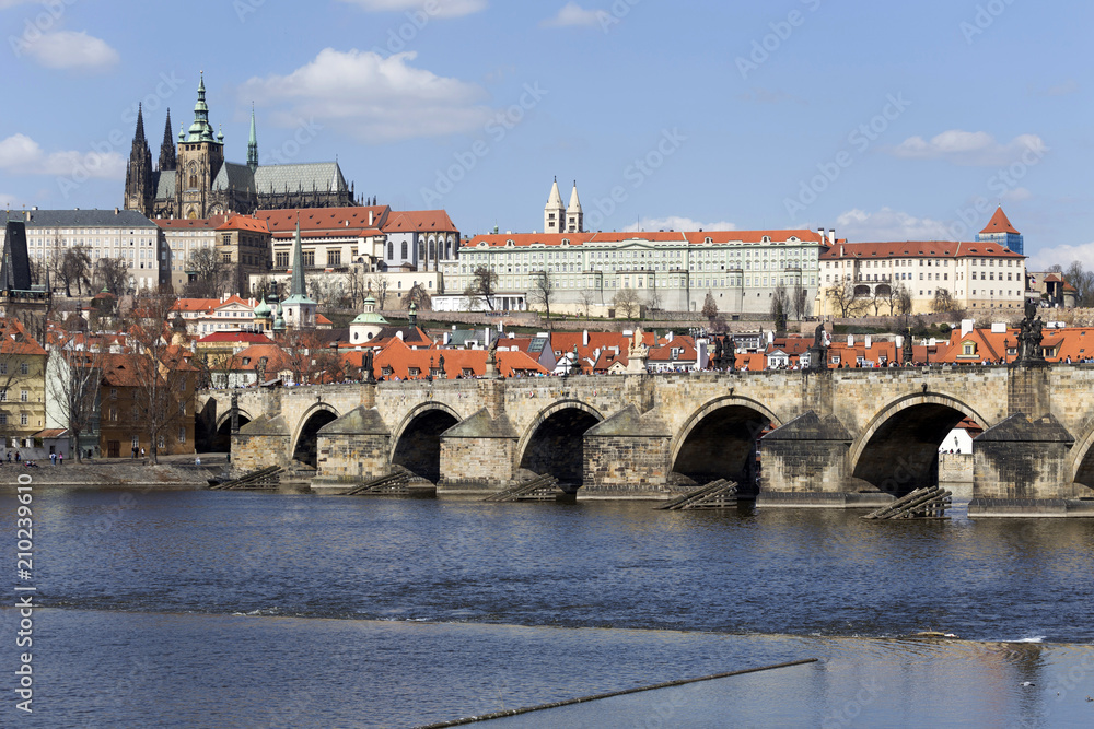 Obraz premium Spring Prague gothic Castle and Charles Bridge with the Lesser Town in the sunny Day, Czech Republic