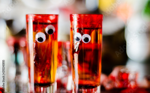creepy halloween party cocktails with blood, spiders and ice cubes