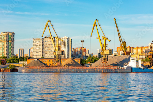 barges and cranes in the river port photo