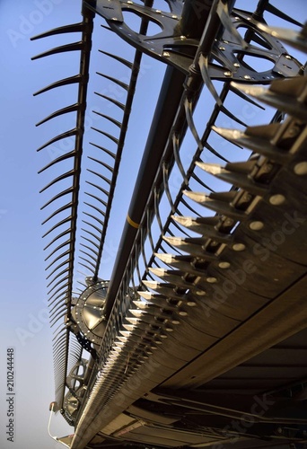 Strong detail of sickle guards on the header of a combine.