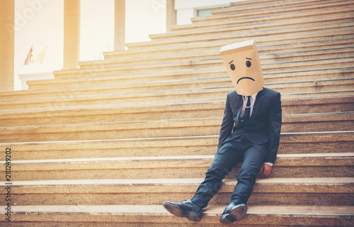 Fotografie, Obraz Businessman masked stress on the company stairs.