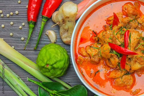 red curry chicken, Thai Spicy food and fresh herb ingredients on wooden top view / still life, selective focus photo