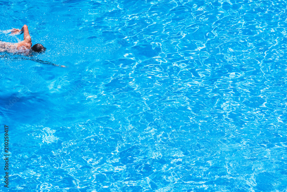Swimmer in an outdoor pool in summer
