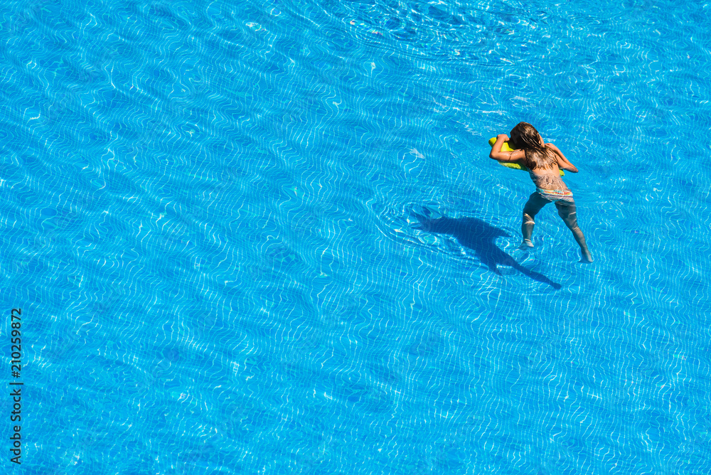 Girls playing with a float in the pool