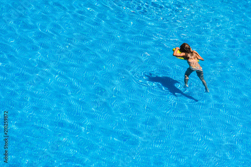 Girls playing with a float in the pool