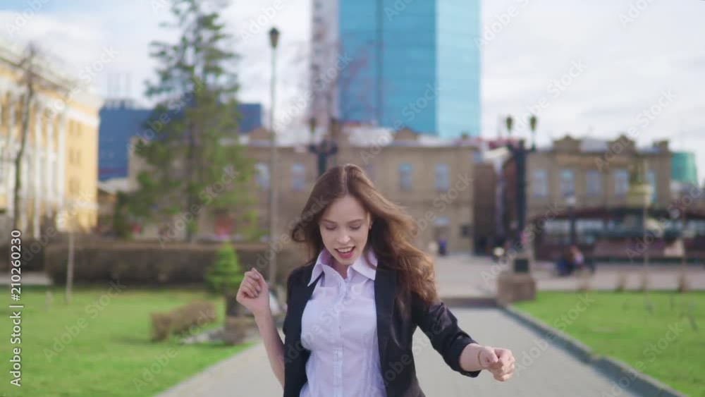 Crazy happy businesswoman dancing in street town corporate celebrating achievement. Crazy happy businesswoman dancing in street town corporate celebrating achievement.