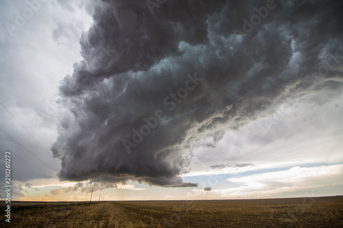 A supercell thunderstorm towers over the landscape of the Great Plains. photo