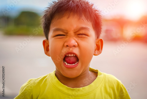 Close-up angry young Asian boy shouting, Portrait serious stern boy