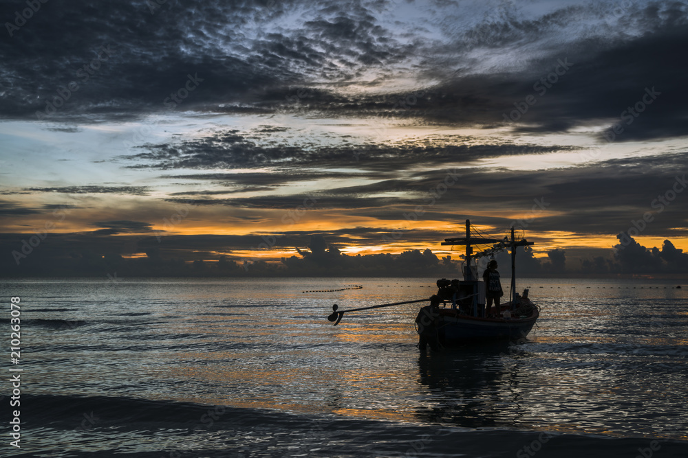 A beautiful tropical dawn with a fishing boat