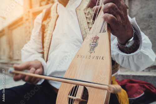 Man Plays Croatian Musical Instrument in Dubrovnik photo