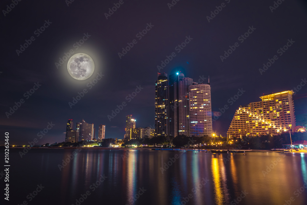 Colorful light Pattaya city in night time with full moon 