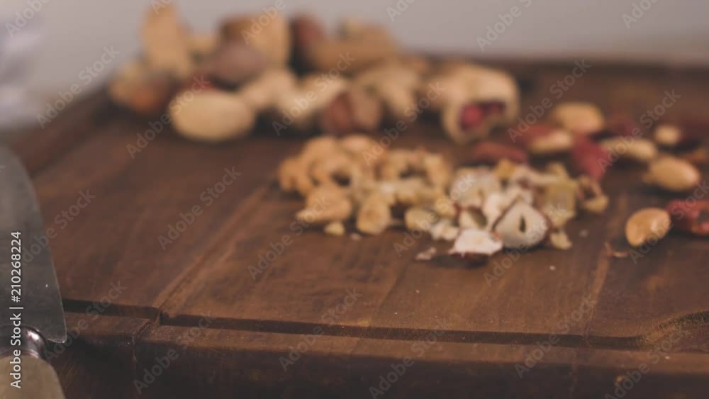 Walnuts, hazelnuts, peanuts and nuts on wooden table. Walnuts, hazelnuts, peanuts and nuts on wooden table.