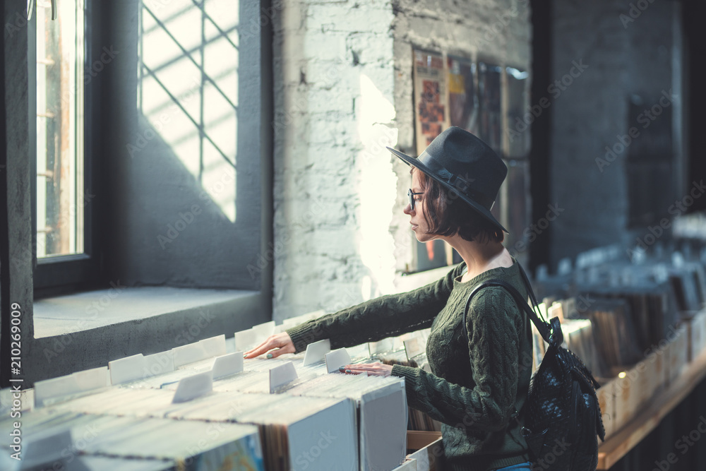Fototapeta premium Young woman in a music store