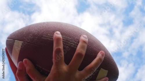 hands catching rugby, football ball, slow motion