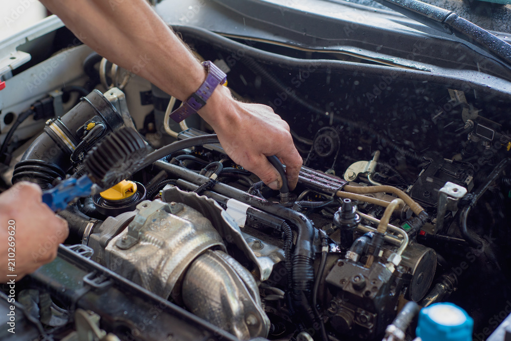 Auto mechanic repairing car. Selective focus. Auto mechanic repairing car. Selective focus.