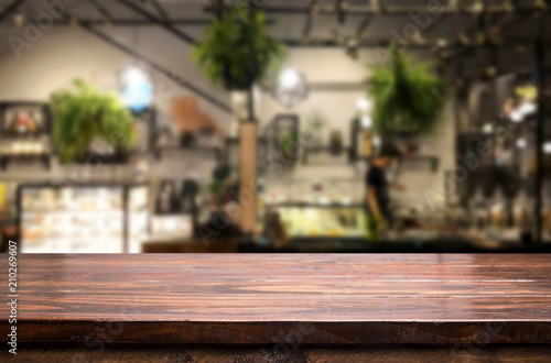 Selected focus empty brown wooden table and Coffee shop or restaurant blur background with bokeh image. for your photomontage or product display © snowing12