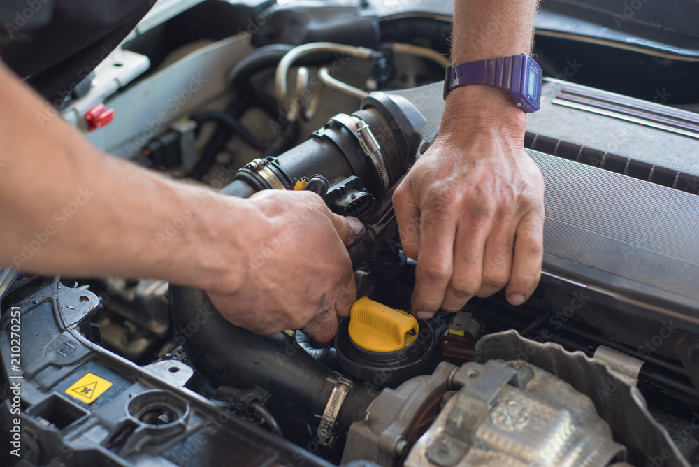 Auto mechanic repairing car. Selective focus. Auto mechanic repairing car. Selective focus.